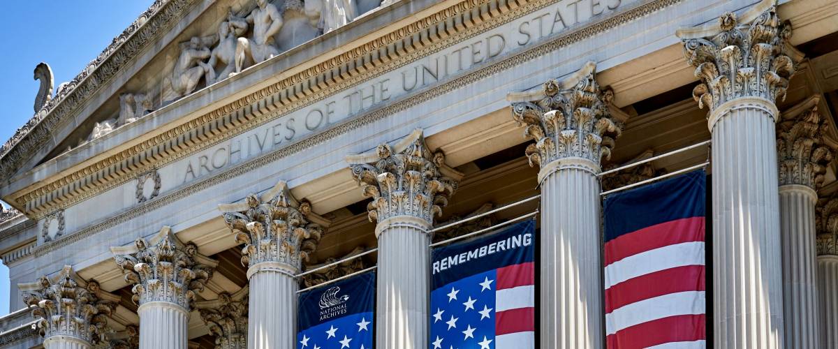 Washington DC, USA - June 5, 2018: Close up looking up at the pillars and exhibit sign on the National Archive building facing Constitution Avenue