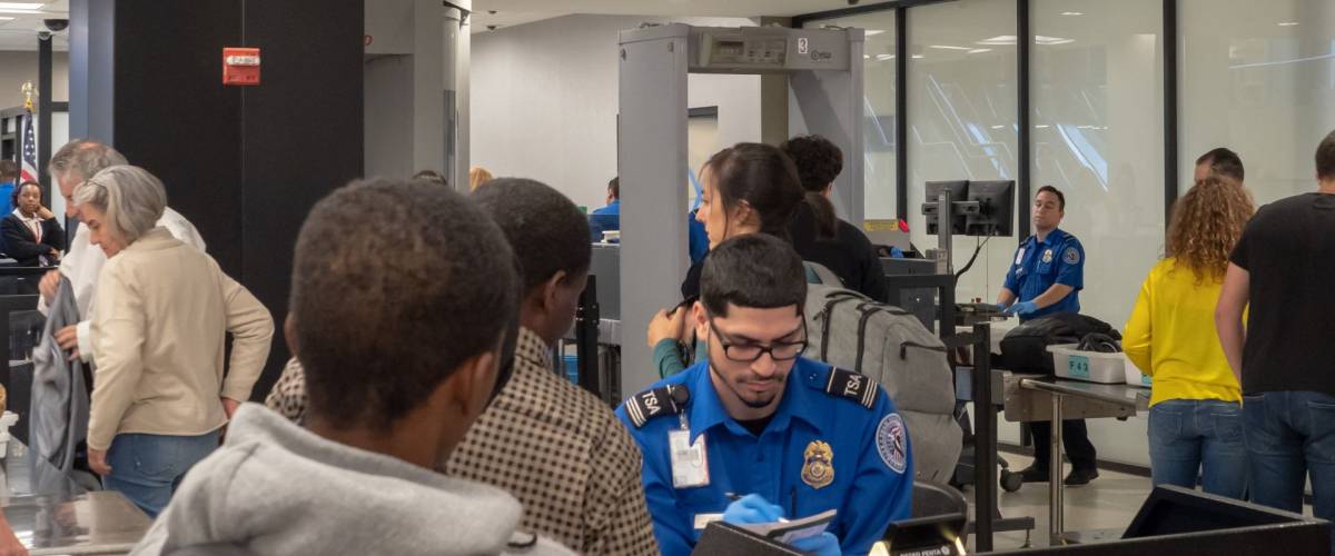 NEW YORK, NY – MAY 19, 2018: Travelers lining up at a Transportation Security Administration (TSA) queue in JFK airport in New York City.