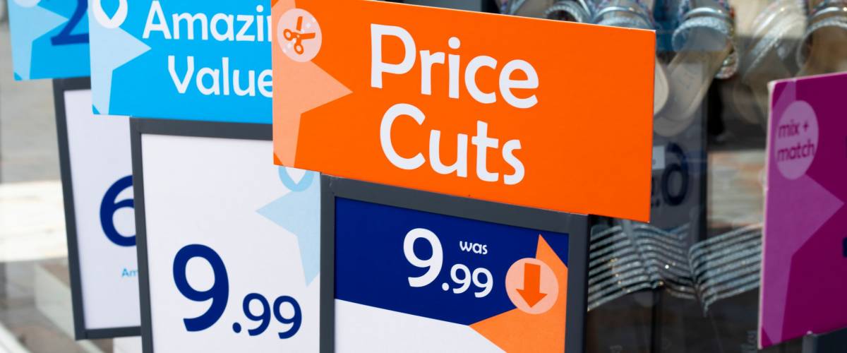 Salisbury, Wiltshire, England - May 04, 2019: price cuts and amazing value signs outside budget shoe shop