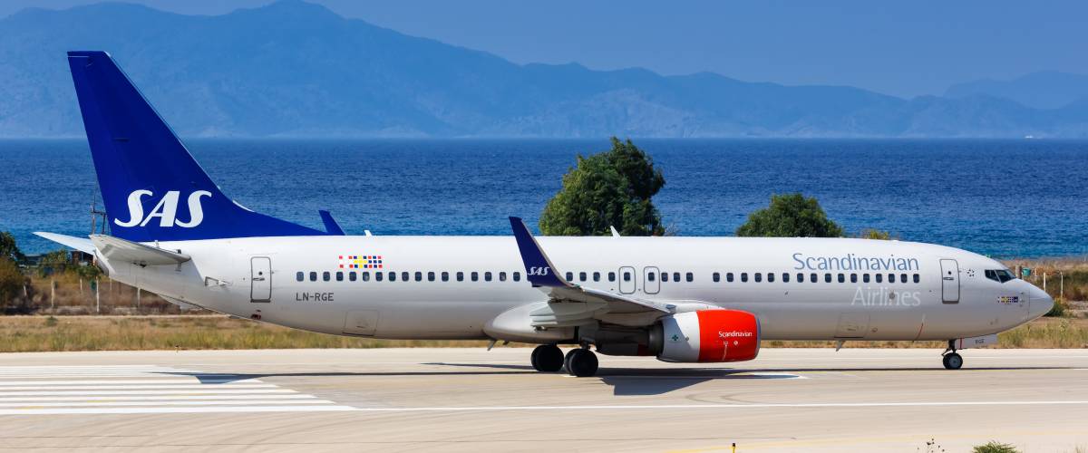 (SAS) Scandinavian Airlines airplane on the runway.