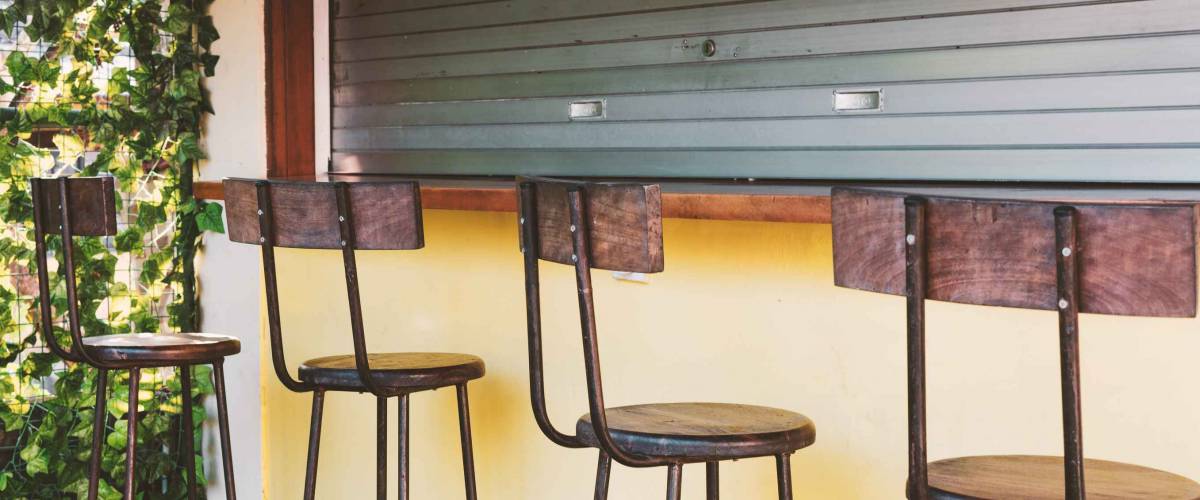 Empty bar - bar stools at the closed bar counter. Small business fail concept