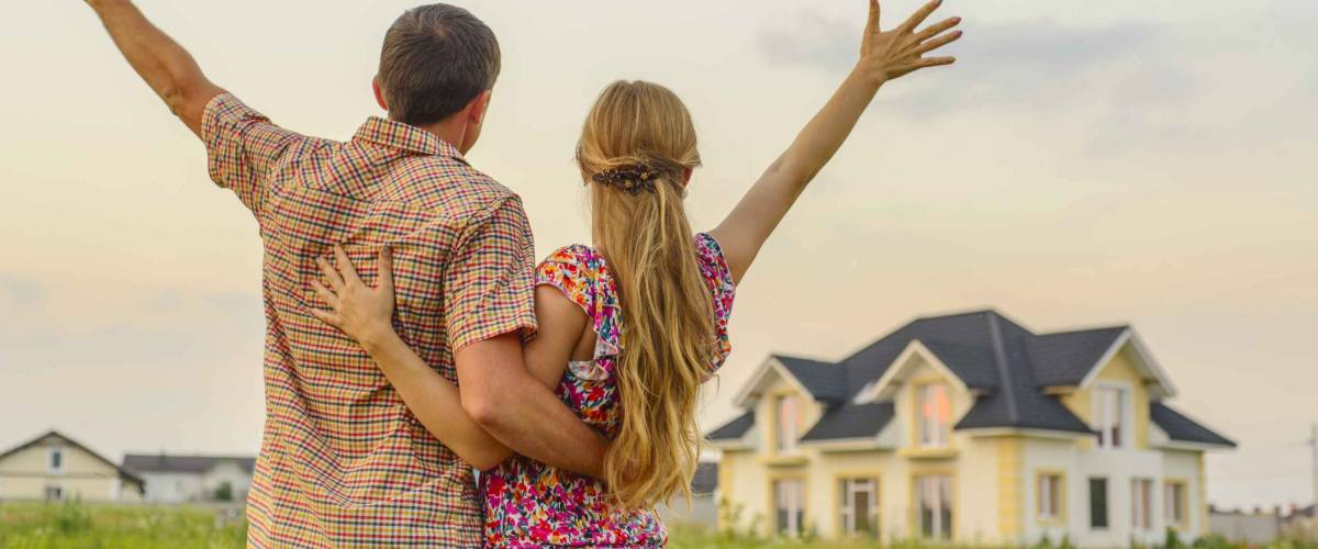 loving couple looking at their home