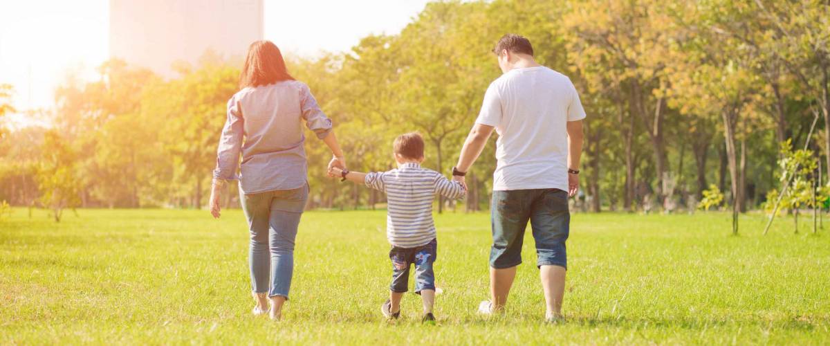 Mother playing with son in the field. Happy family life style concept.