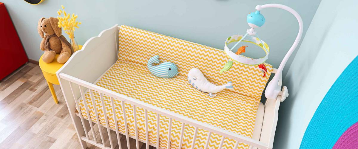 Interior of baby room with comfortable crib
