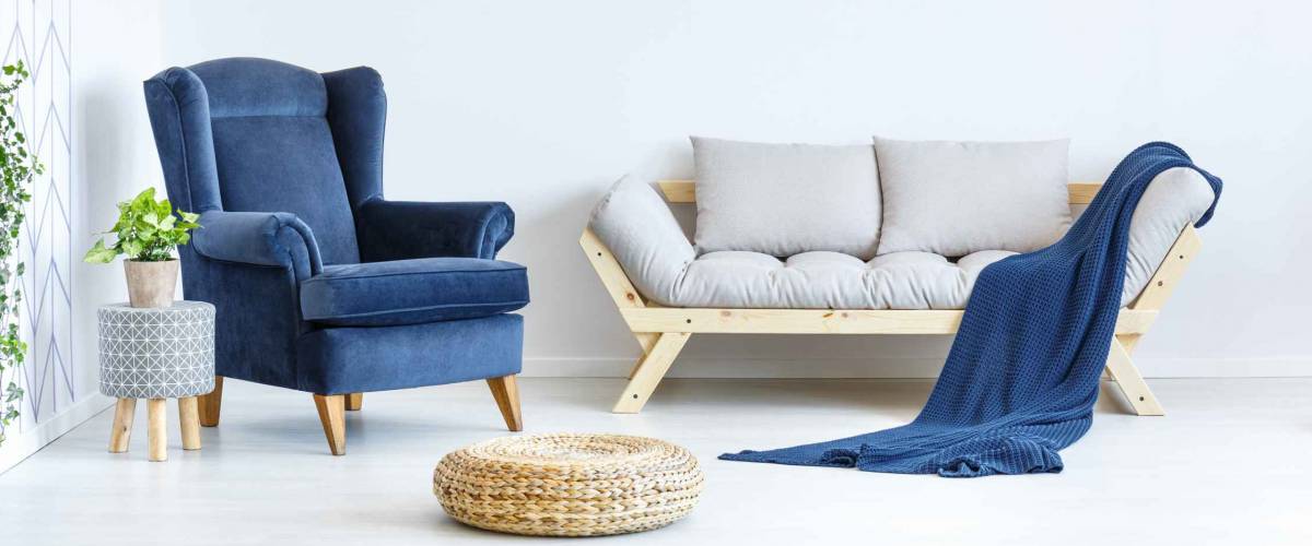 White and blue living room with sofa, armchair
