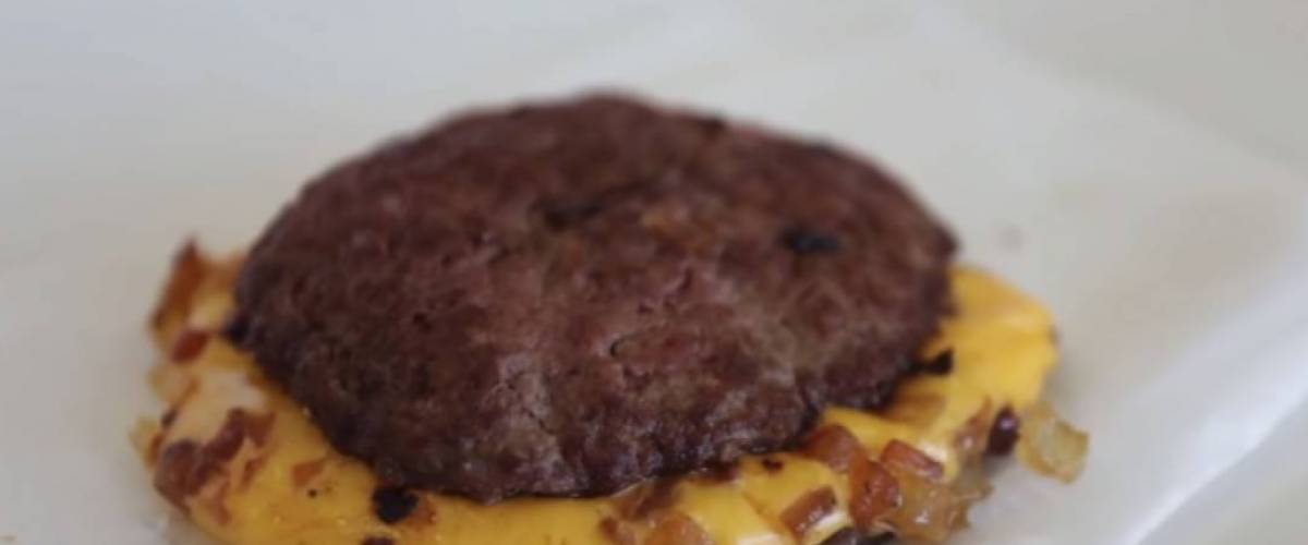 Two burger patties separated by cheese