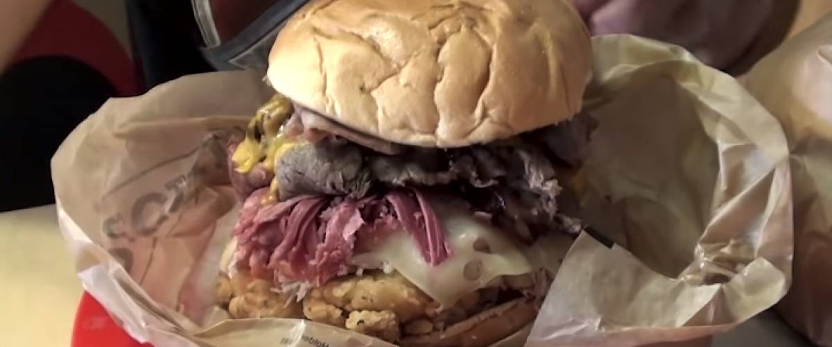 Burger stuffed with chicken tenders, roast turkey, smoked ham, corned beef, brisket, Angus steak, roast beef and bacon
