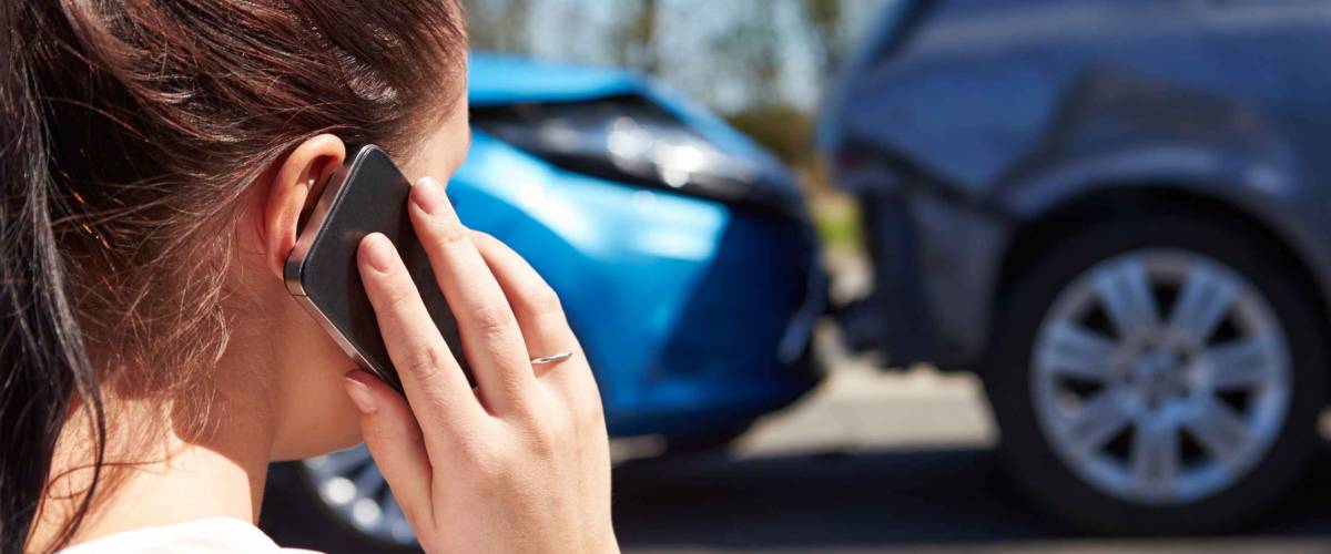 Stressed Driver Sitting At Roadside After Traffic Accident