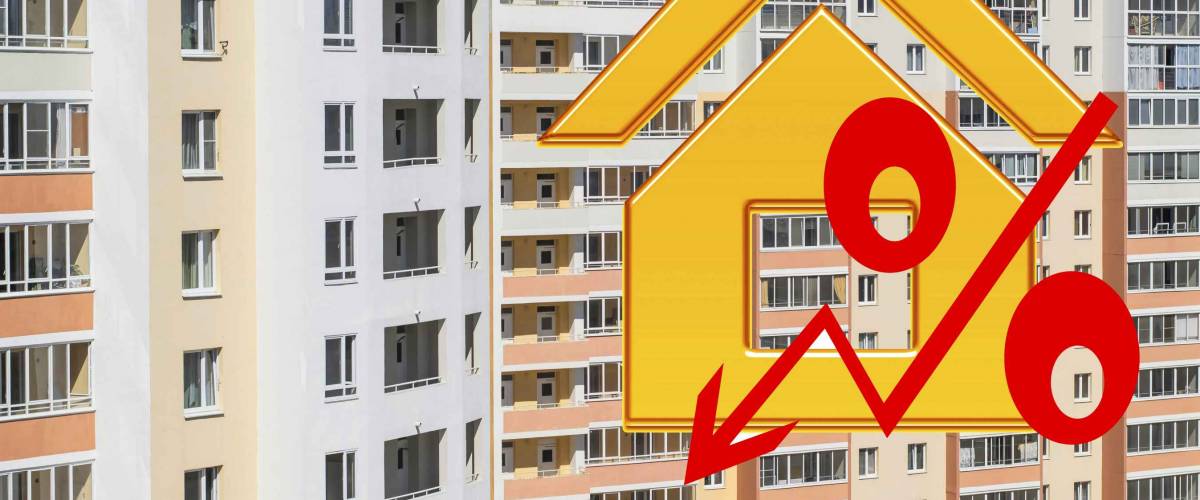Red percent sign on the background of houses . The concept of price changes on the real estate market .